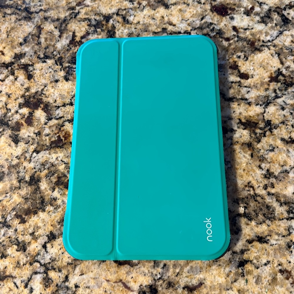 Nook reader with green case and charger cord